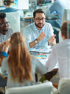 A group of employees gathered around a table during a productive meeting.